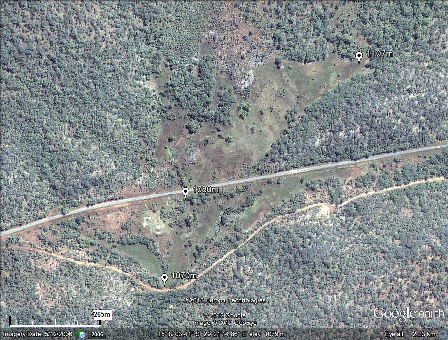 The Nyabutaye Dambo. The former alignment of the Great East Road crossed the Nyabutaye at its outlet from the dambo (at the 1070m altitude marker). The current alignment cuts the dambo roughly in half. The peat bog occupies most of the open terrain to the north of the road, and is flanked by two semi-permanent streams. The Nyabutaye Dambo. The former alignment of the Great East Road crossed the Nyabutaye at its outlet from the dambo (at the 1070m altitude marker). The current alignment cuts the dambo roughly in half. The peat bog occupies most of the open terrain to the north of the road, and is flanked by two semi-permanent streams.